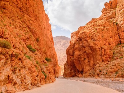 Todra Gorge orange cliffs with narrow pathway between two cliffs, Morocco